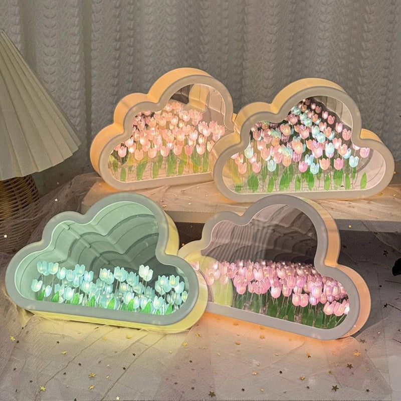 Four cloud tulip mirror lamps glowing together in pink, blue and mixed tulip colors on a table