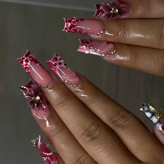 Assorted press-on nail design — long square pink nails with leopard print and 3D floral detail