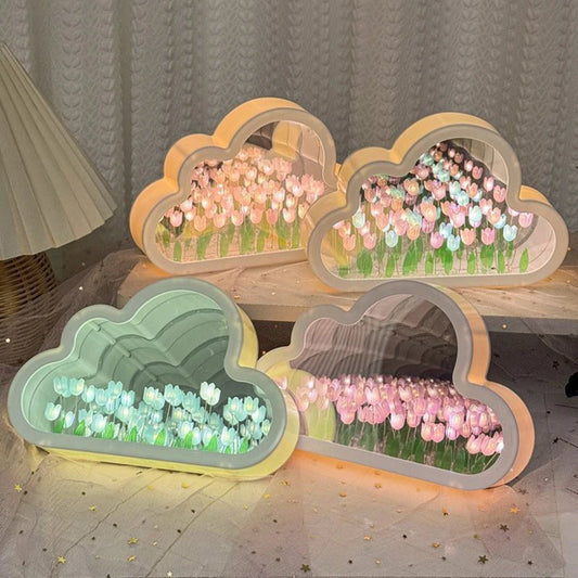Four cloud tulip mirror lamps glowing together in pink, blue and mixed tulip colors on a table