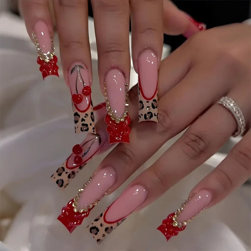 Long square press-on nails on both hands — leopard French tips with 3D cherries, bows and rhinestones