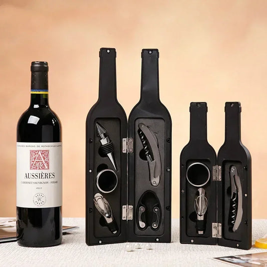 Wine opener gift set in two open black bottle-shaped cases — corkscrew, pourer, stopper, foil cutter — beside a wine bottle